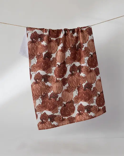 A Geometry Harvest Moon kitchen tea towel on display